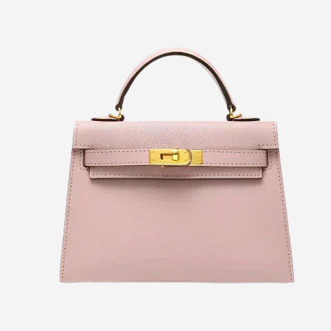 A pink leather handbag with a gold lock detail and a gold-colored handle.