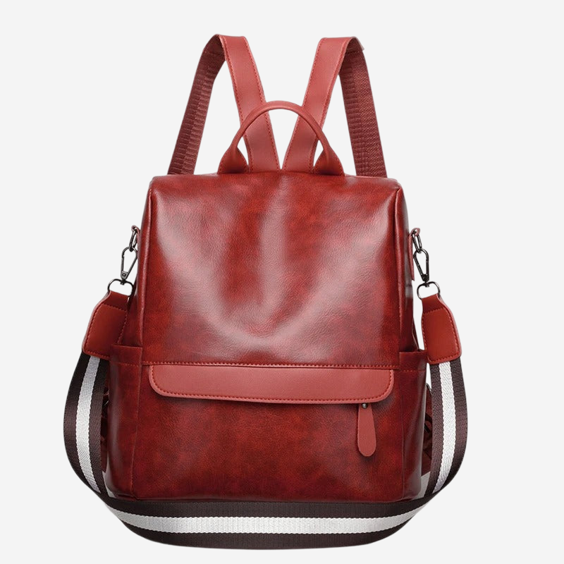 A red leather backpack with a black and white striped strap.