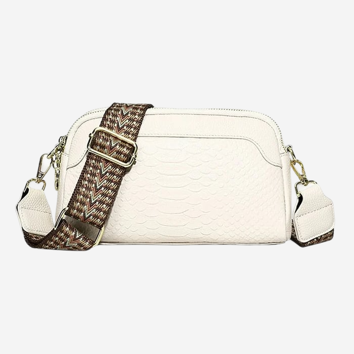 A white crossbody bag with a brown patterned strap.