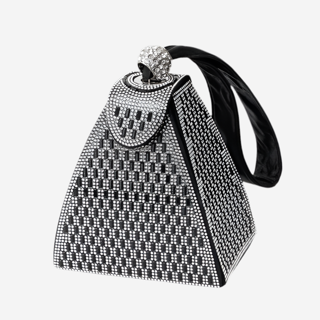 A black and white triangular handbag with a sparkling crystal embellishment on the top.