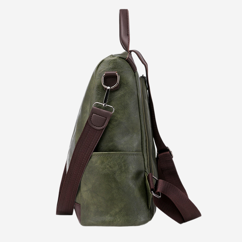 A green leather backpack with a brown strap and a metal clasp on the top.