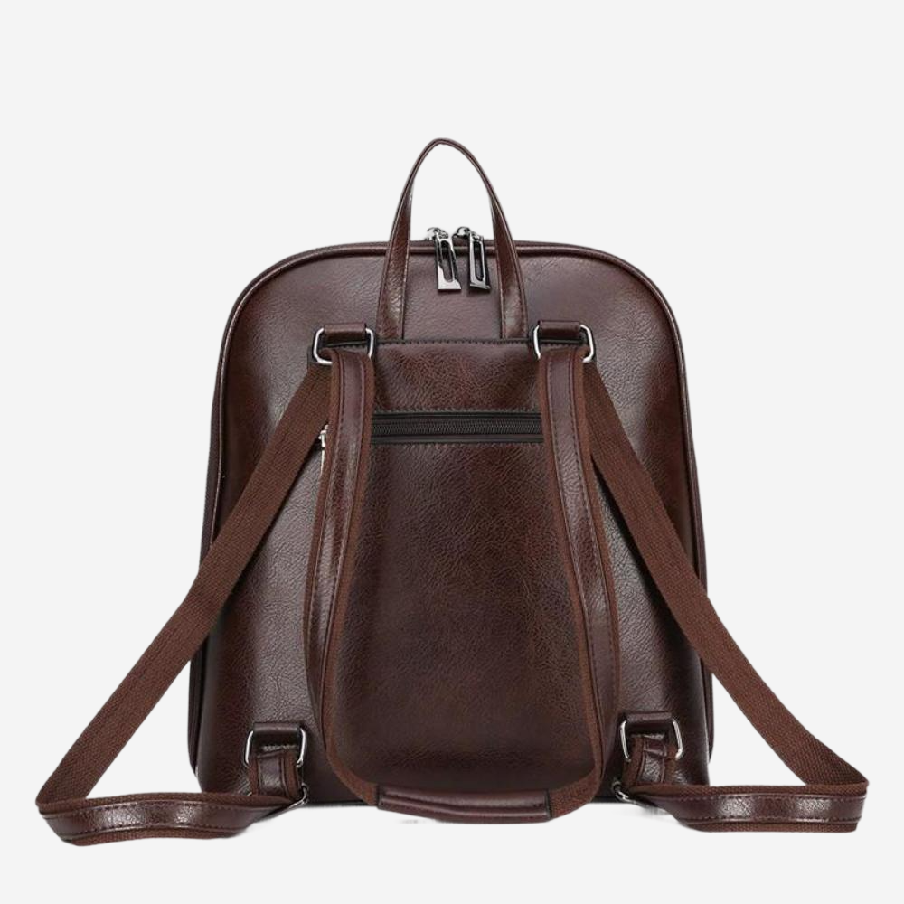 A brown leather backpack with multiple straps and zippers.