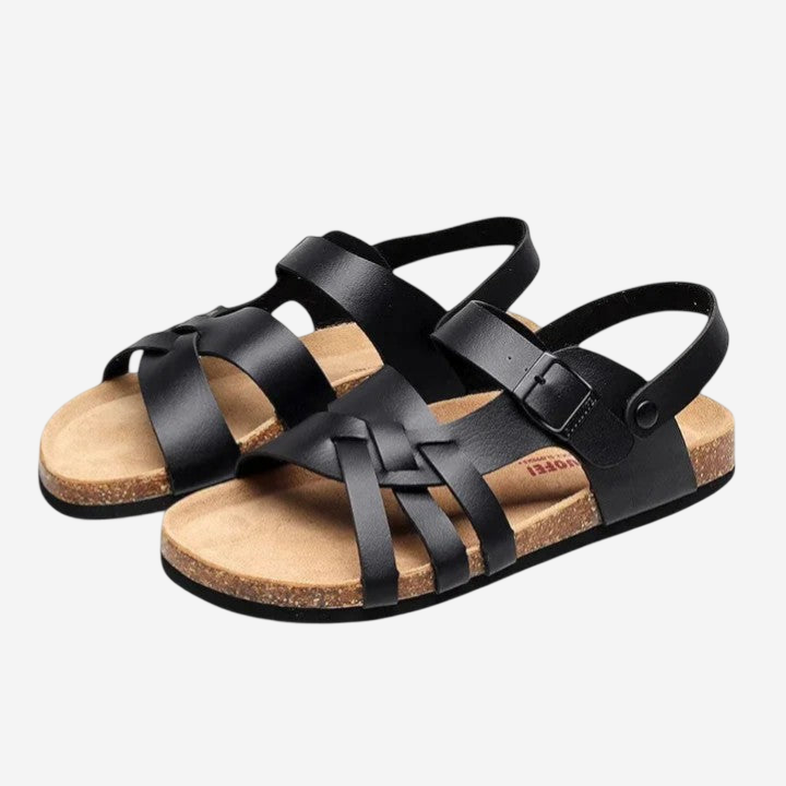 A pair of black sandals with a cork sole and braided straps.