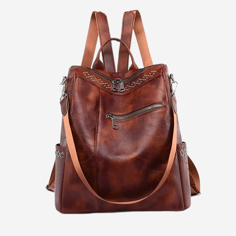 A brown leather backpack with multiple pockets and zippers, featuring a leather strap and a zipper closure.