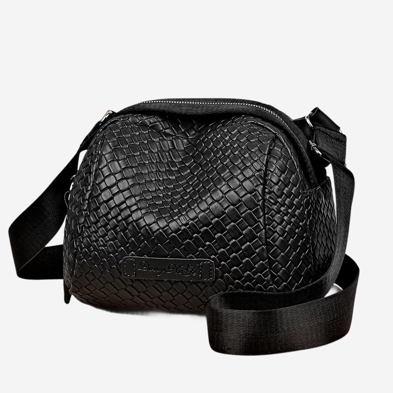 A black leather crossbody bag with a distinctive snake skin texture and a zipper closure.