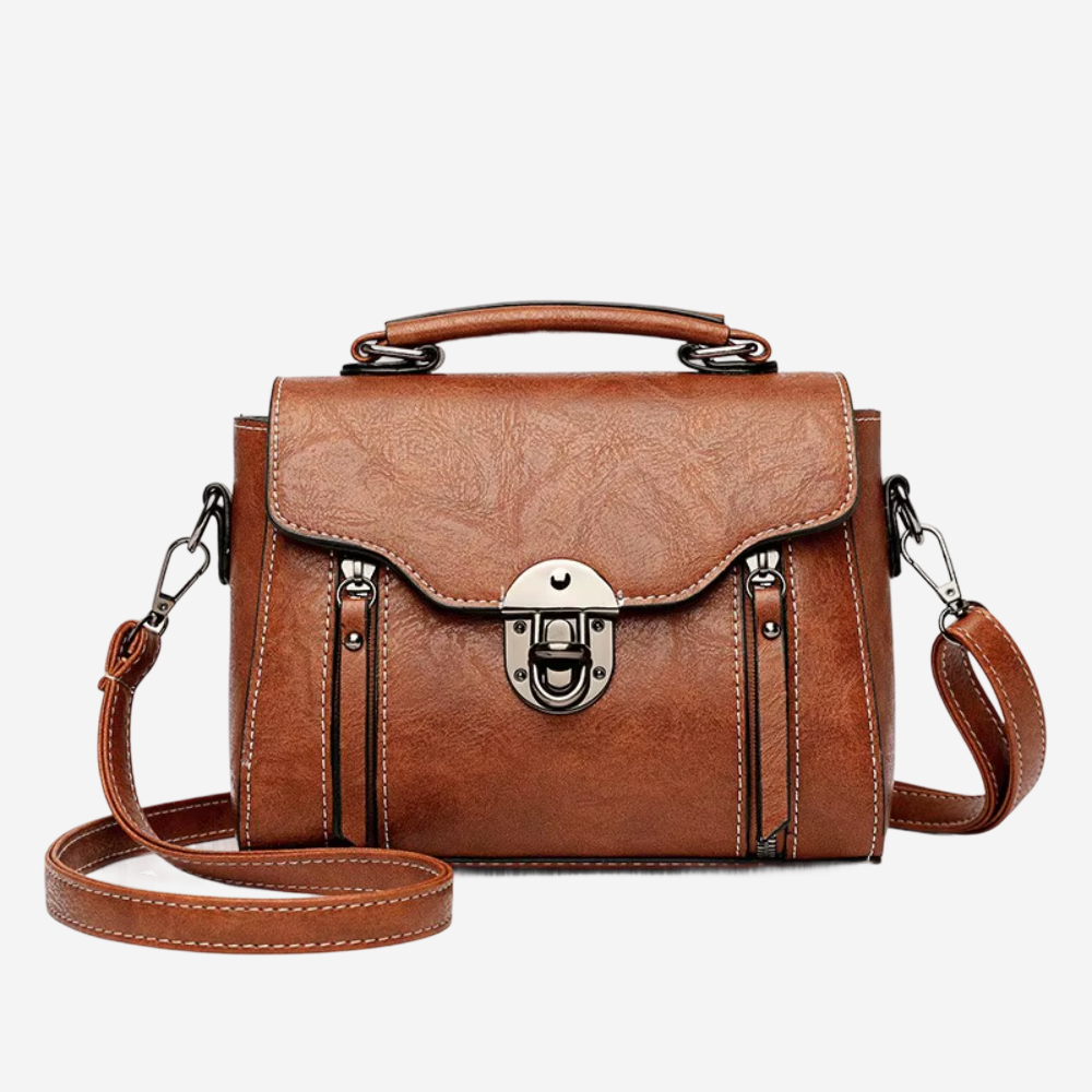 A brown leather handbag with a metal clasp and handle, featuring multiple pockets and straps.