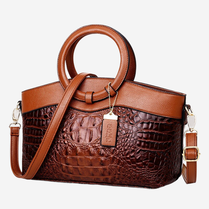 A brown leather handbag with a crocodile skin texture, featuring a round handle and a chain strap.