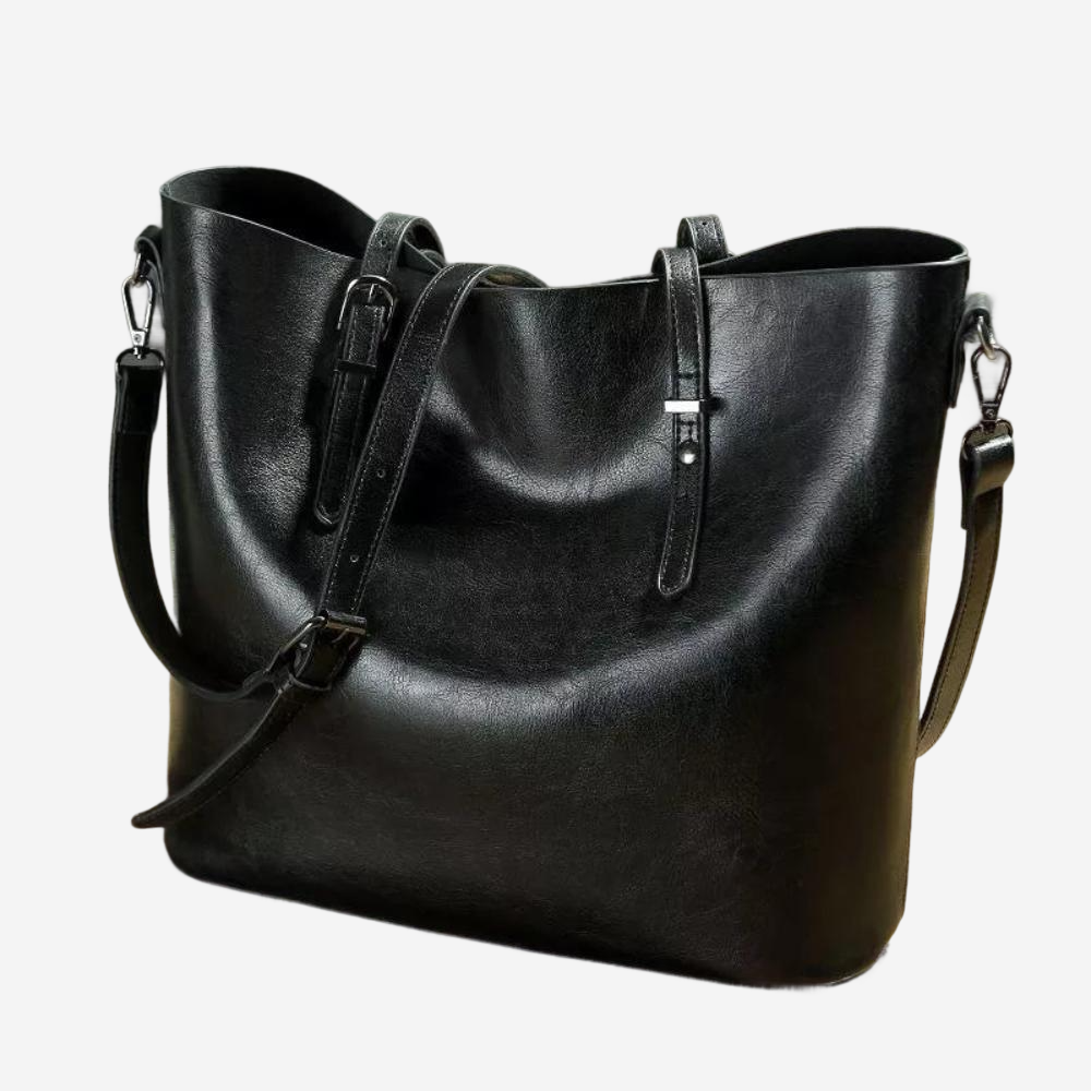 A black leather tote bag with a curved shape and two shoulder straps.