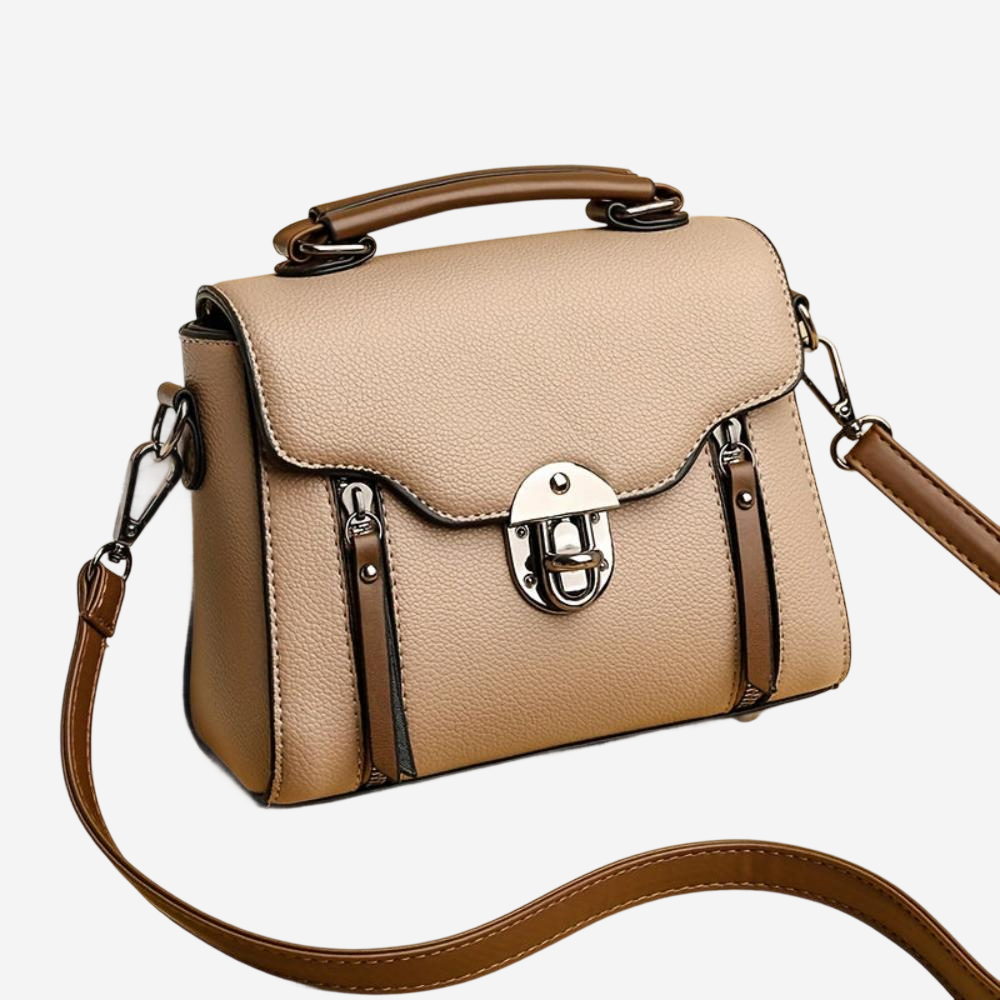 A tan leather handbag with a round metal lock closure and a brown leather strap.