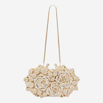 A gold-colored clutch purse with a floral design on the front.