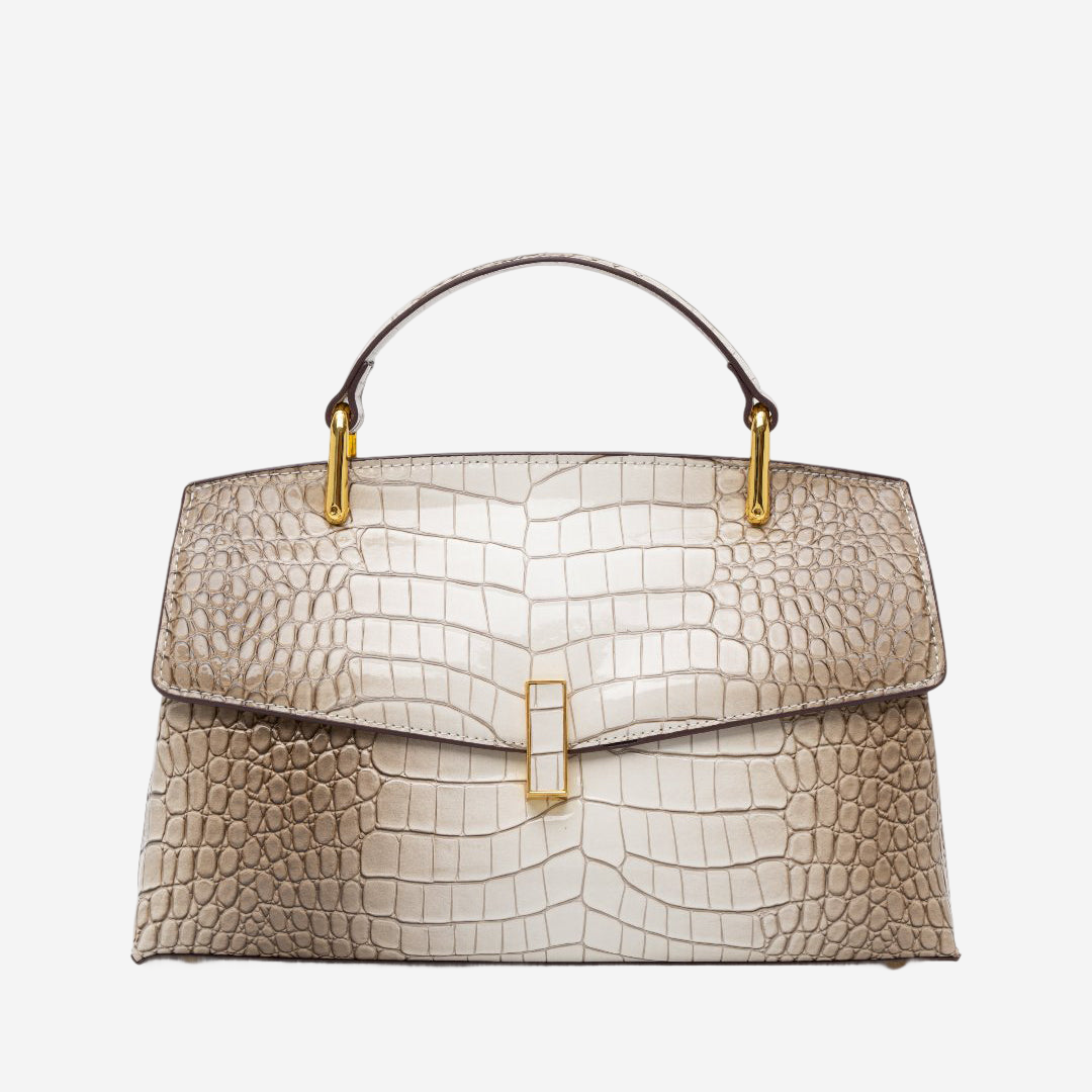 A tan and gold handbag with a crocodile skin texture and gold hardware.