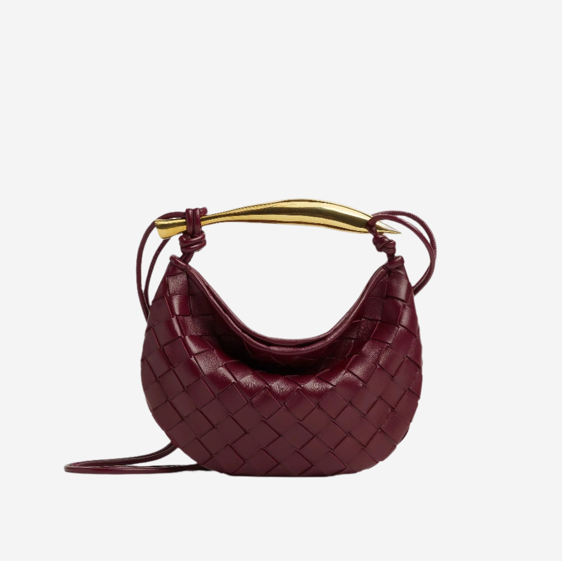 A burgundy woven handbag with a gold handle and strap.