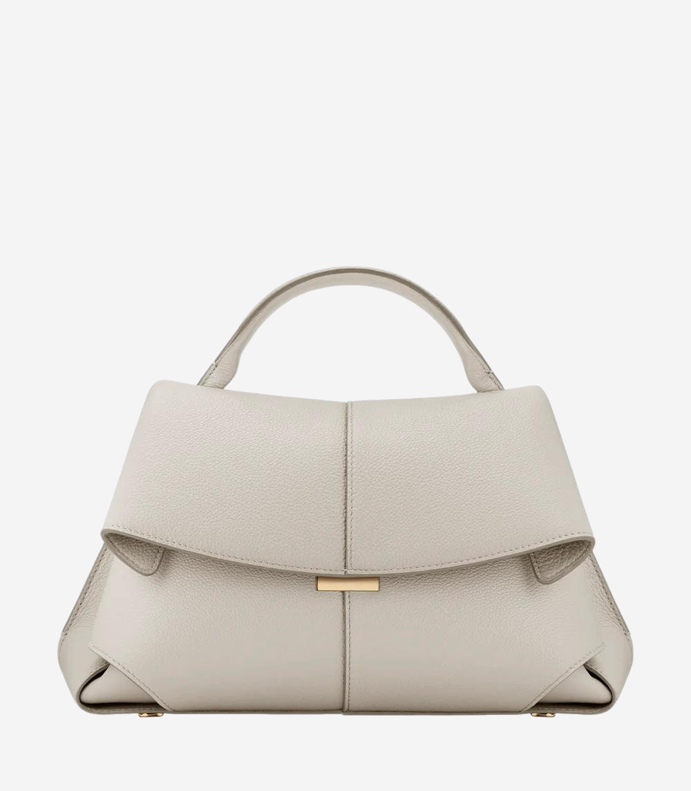 A beige leather handbag with a gold-colored clasp and handle.