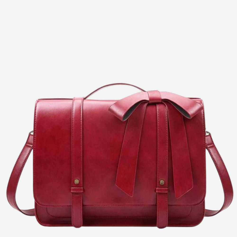 A red leather handbag with a bow detail on the front.