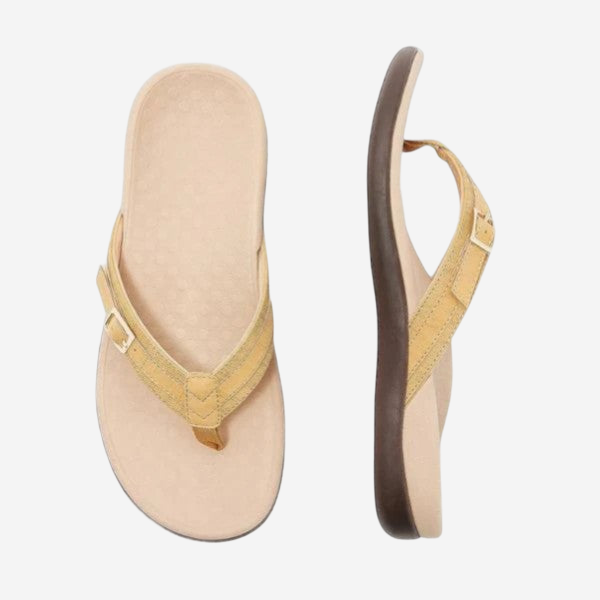 A pair of tan-colored flip-flops with brown straps.