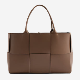 A large brown leather tote bag with a distinctive woven pattern.