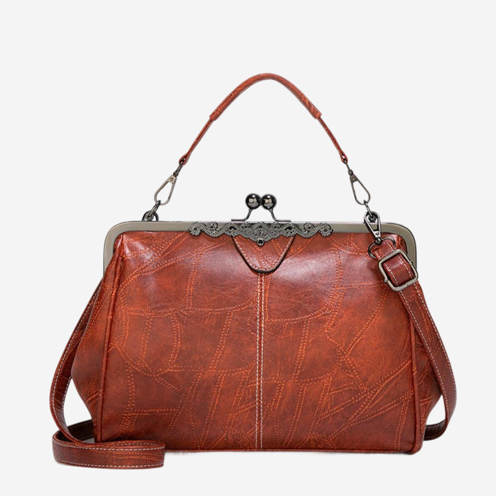 A brown leather handbag with a metal clasp and handle, featuring a distinctive design and texture.