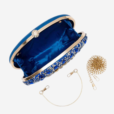 A blue clutch purse with a gold chain strap and a small gold chain attached to it.