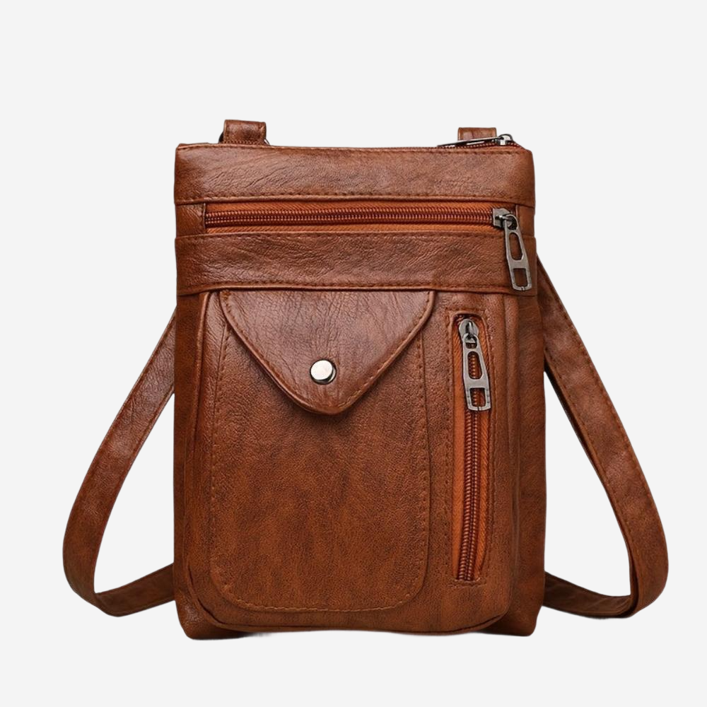 A brown leather crossbody bag with multiple pockets and zippers.