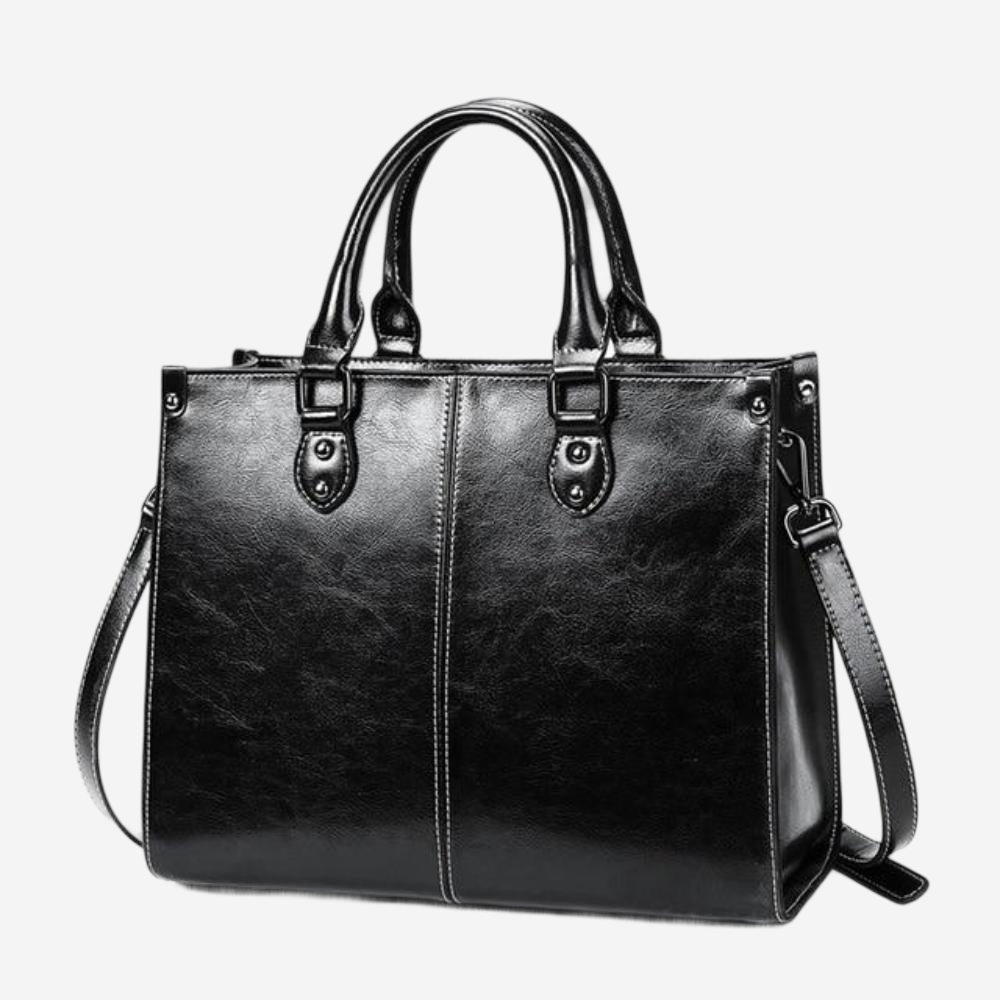 A black leather handbag with two handles and a shoulder strap.