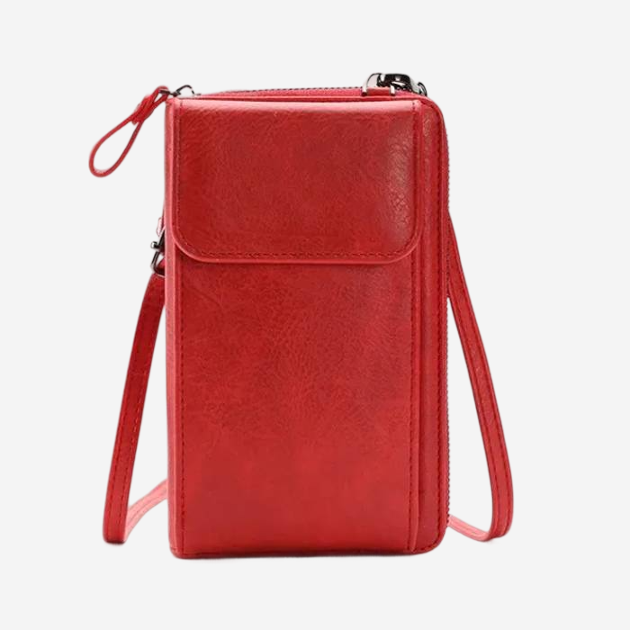 A red leather crossbody bag with a zipper closure and a front pocket.