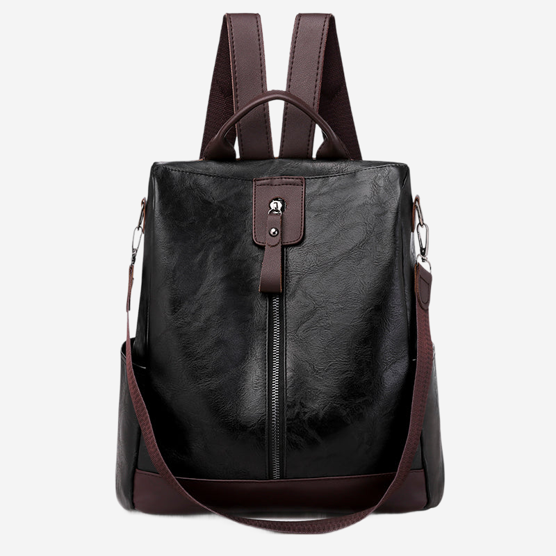 A black leather backpack with a brown strap and handle.