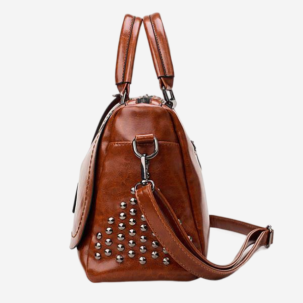 A brown leather handbag with studded details and two handles.