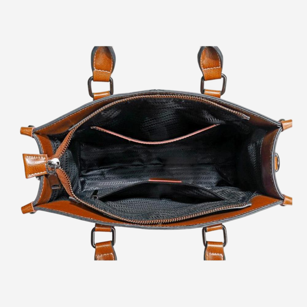 the interior of a brown leather handbag with a black interior lining.