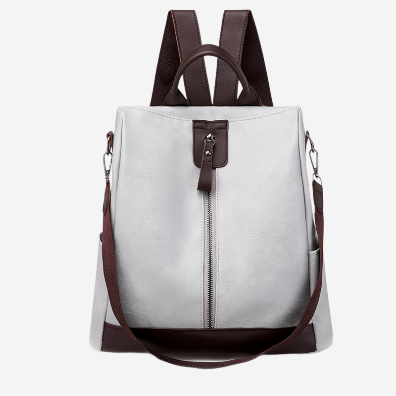A white and brown backpack with a zipper closure and a brown strap.