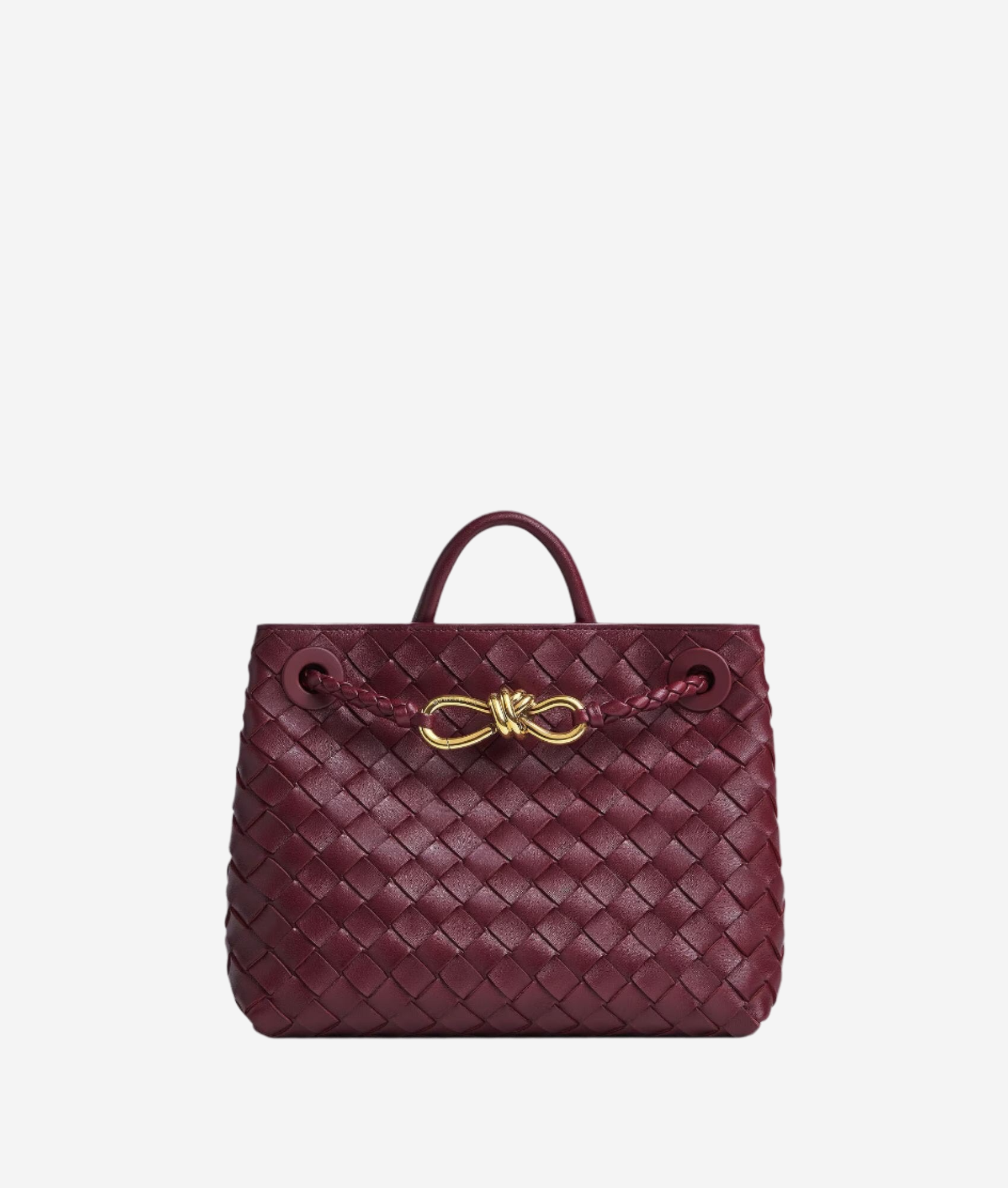 A burgundy woven handbag with a gold buckle detail.
