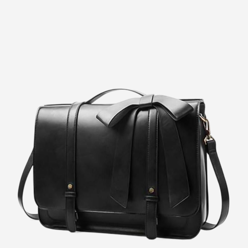 A black leather satchel with a bow detail on the front.