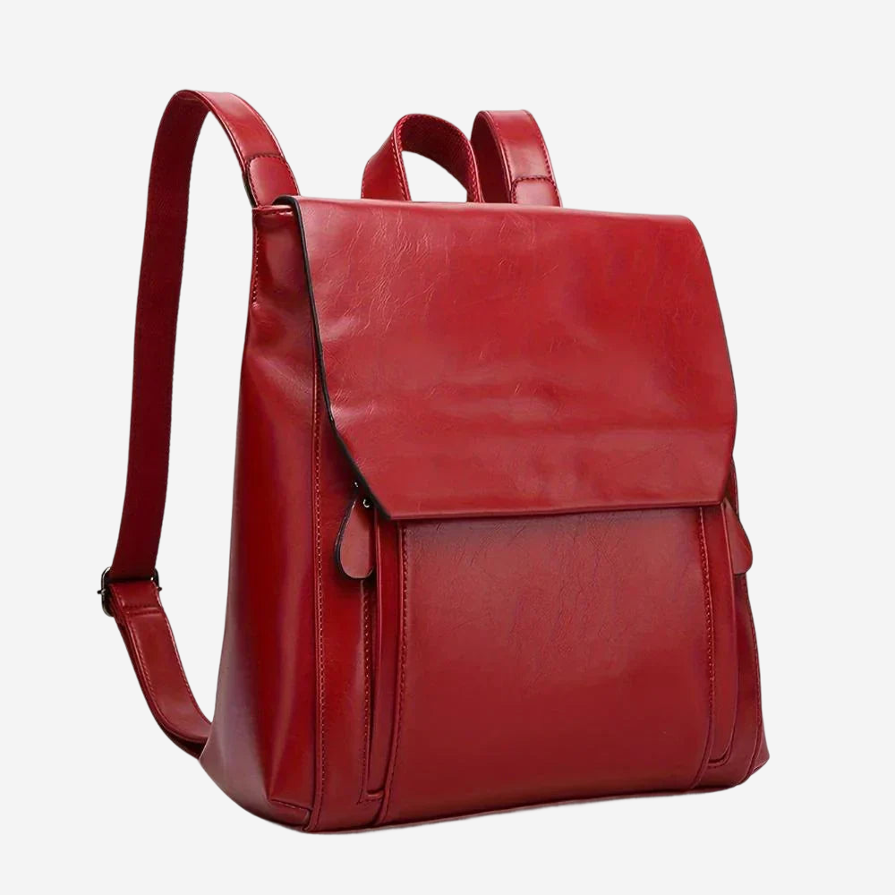 A red leather backpack with a flap closure and two shoulder straps.
