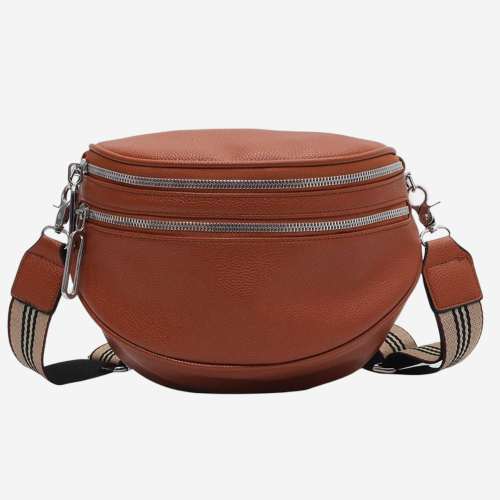 A brown leather crossbody bag with multiple zippers and a striped strap.