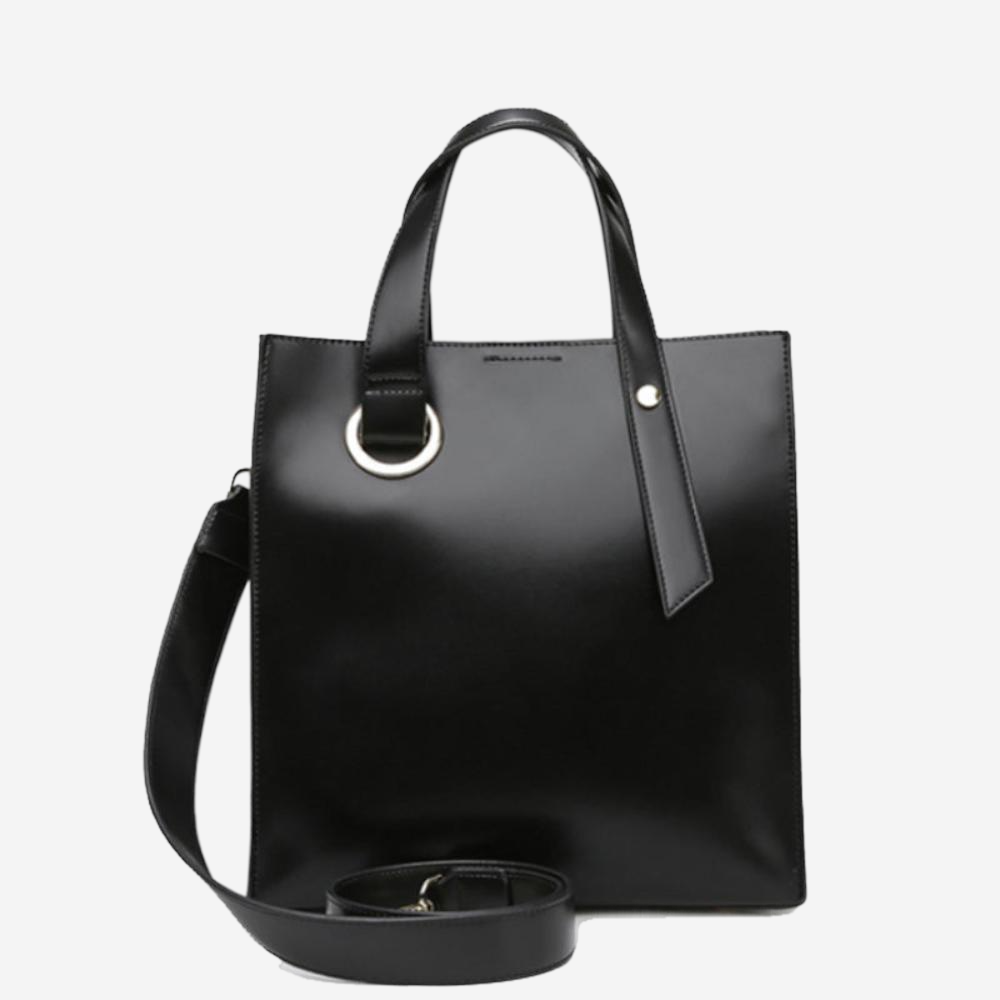 A black leather tote bag with a metal ring on the front and a black strap.