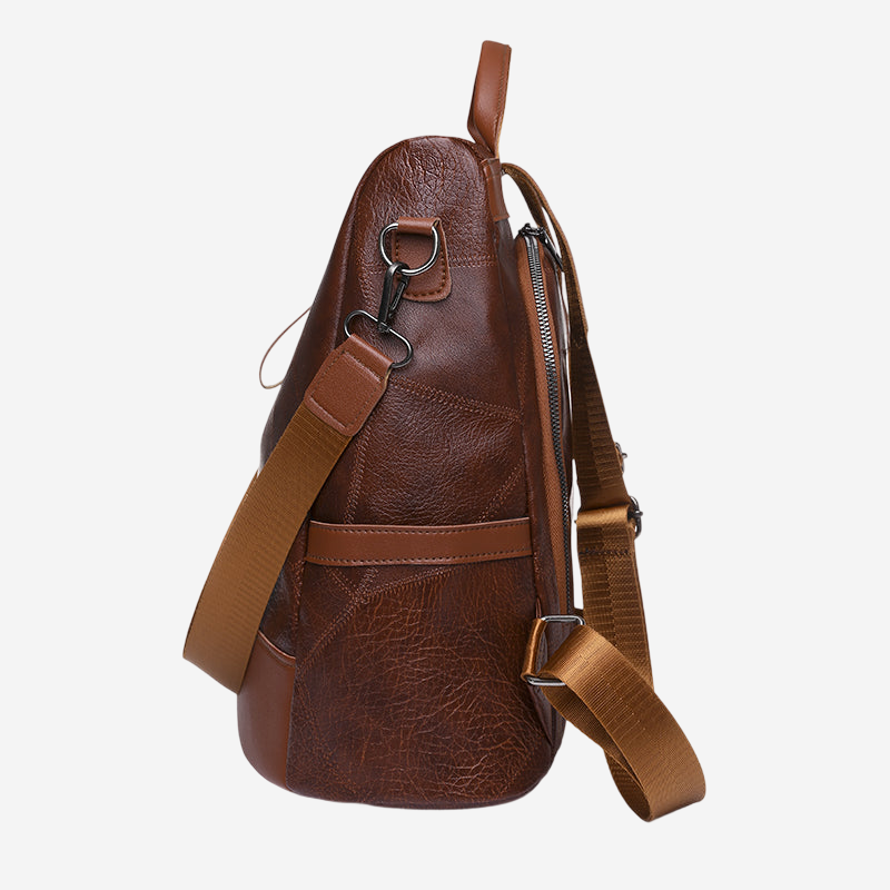 A brown leather backpack with a leather strap and metal clasp.