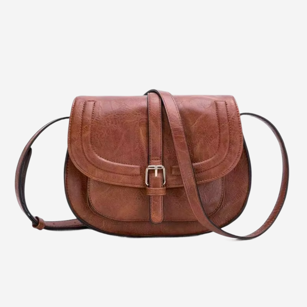 A brown leather crossbody bag with a curved front and two straps.