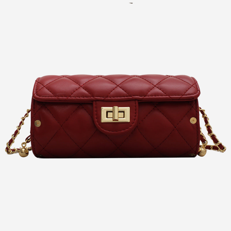 A red quilted leather handbag with a gold lock closure and chain strap.