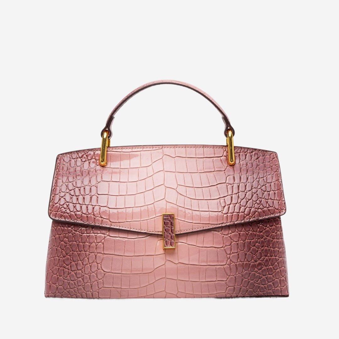A pink crocodile skin handbag with a gold-colored handle and clasp.