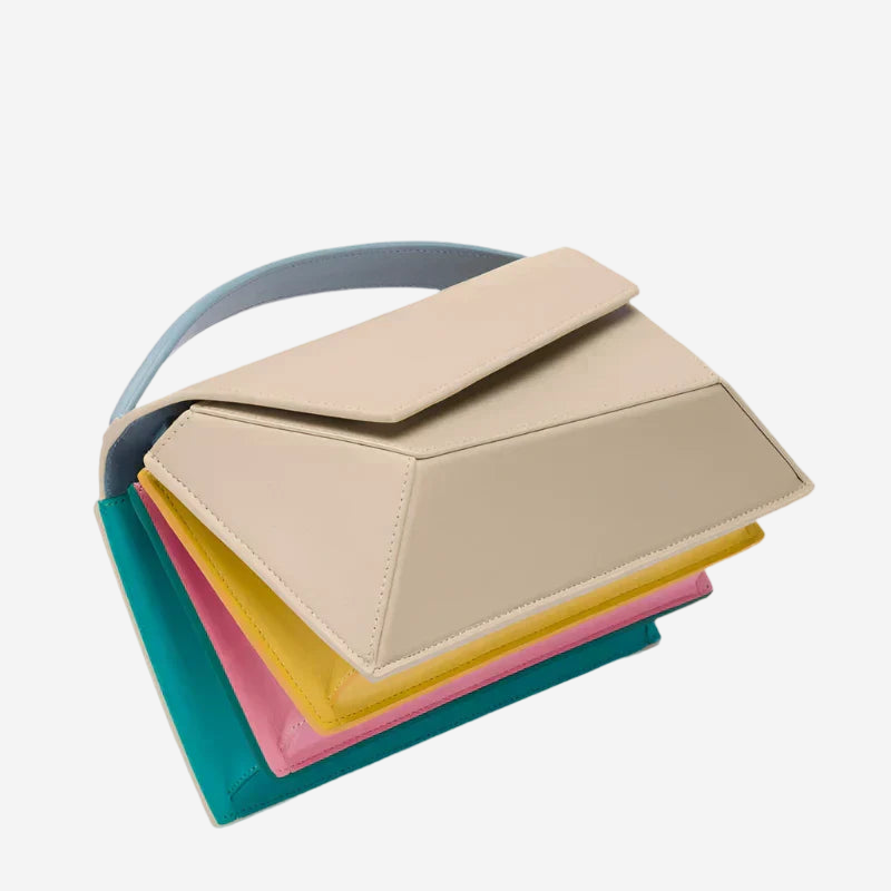 A multi-colored handbag with a geometric pattern and a blue handle.