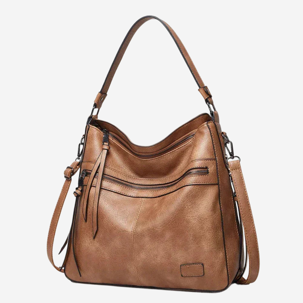 A tan leather shoulder bag with multiple pockets and a long strap.