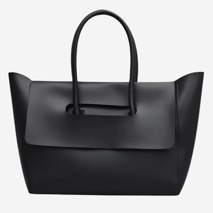 A black leather tote bag with a curved handle and a flap closure.