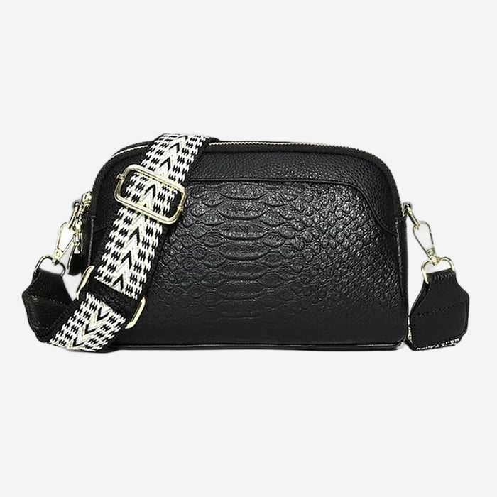 A black leather crossbody bag with a patterned strap.