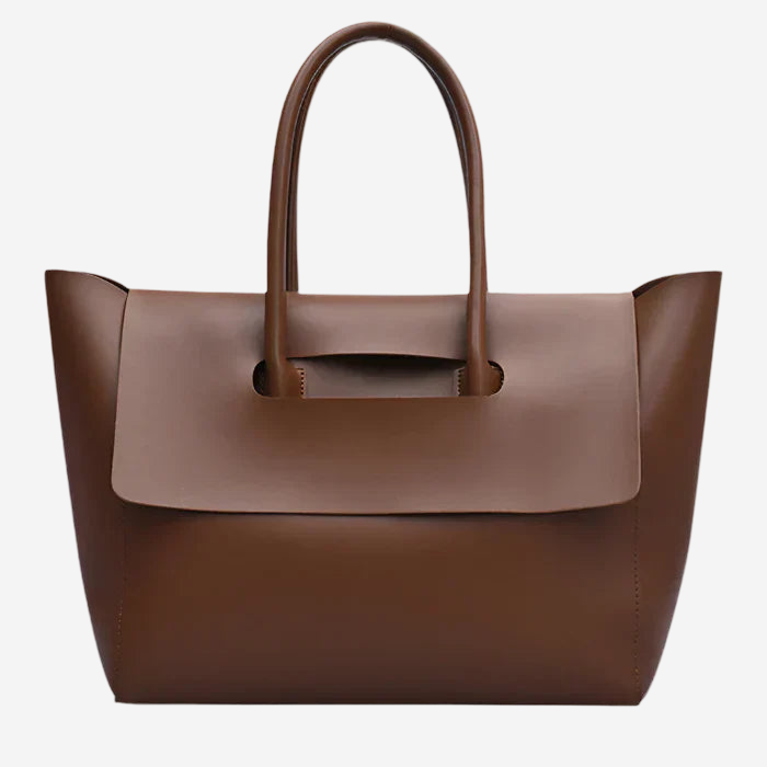 A brown leather tote bag with a curved handle and a flap closure.