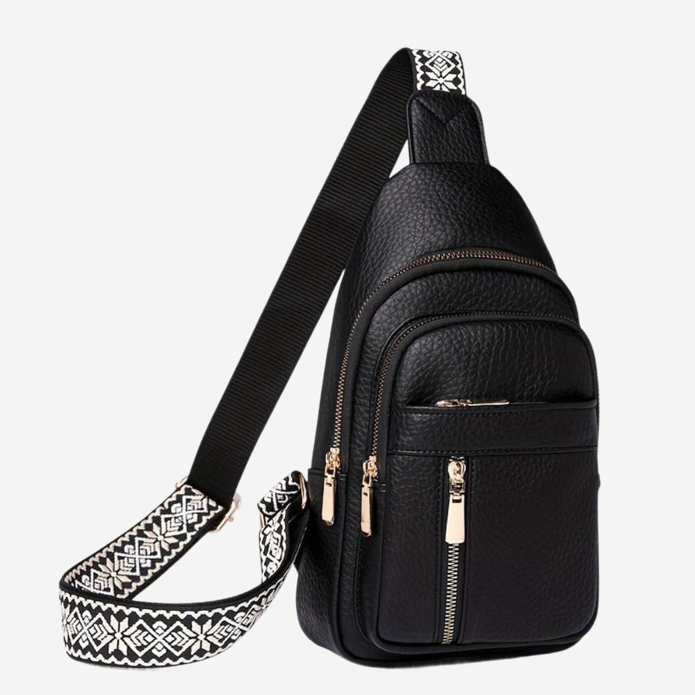 A black crossbody bag with a patterned strap and multiple zipper pockets.