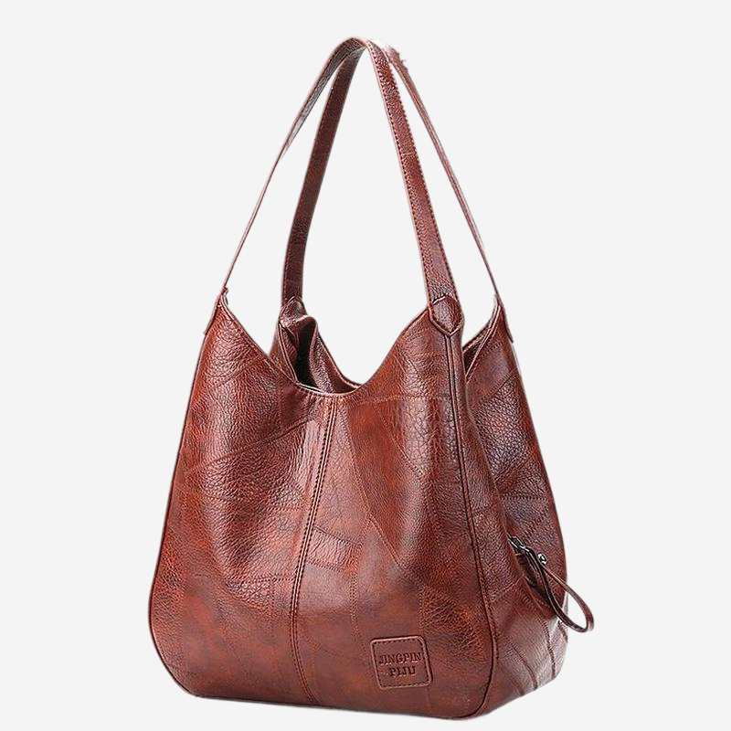 A brown leather handbag with a curved handle and a small logo on the front.
