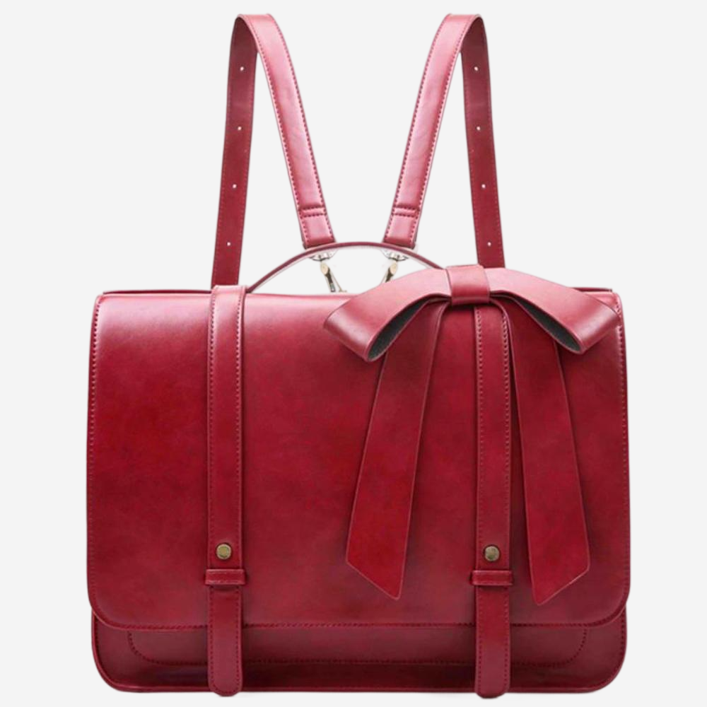 A red leather backpack with a bow on the front.