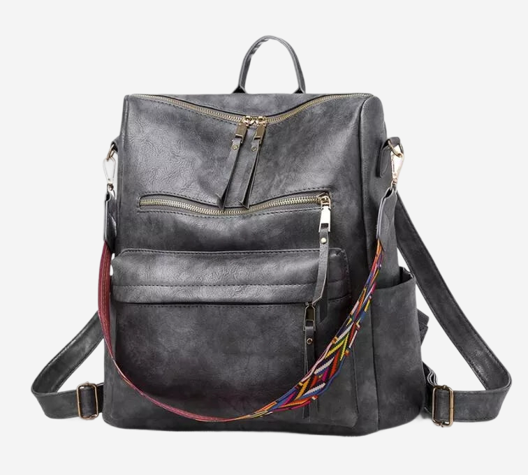 A black leather backpack with multiple zippers and a colorful strap.