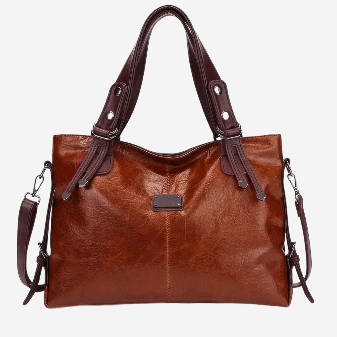 A brown leather handbag with a curved handle and two straps.