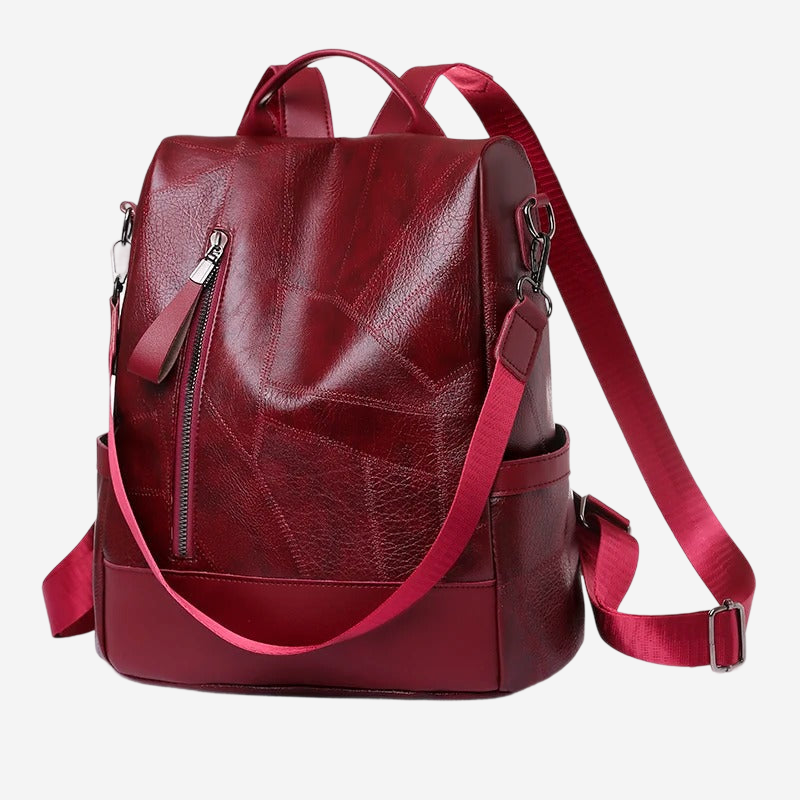 A red leather backpack with multiple zippers and straps.
