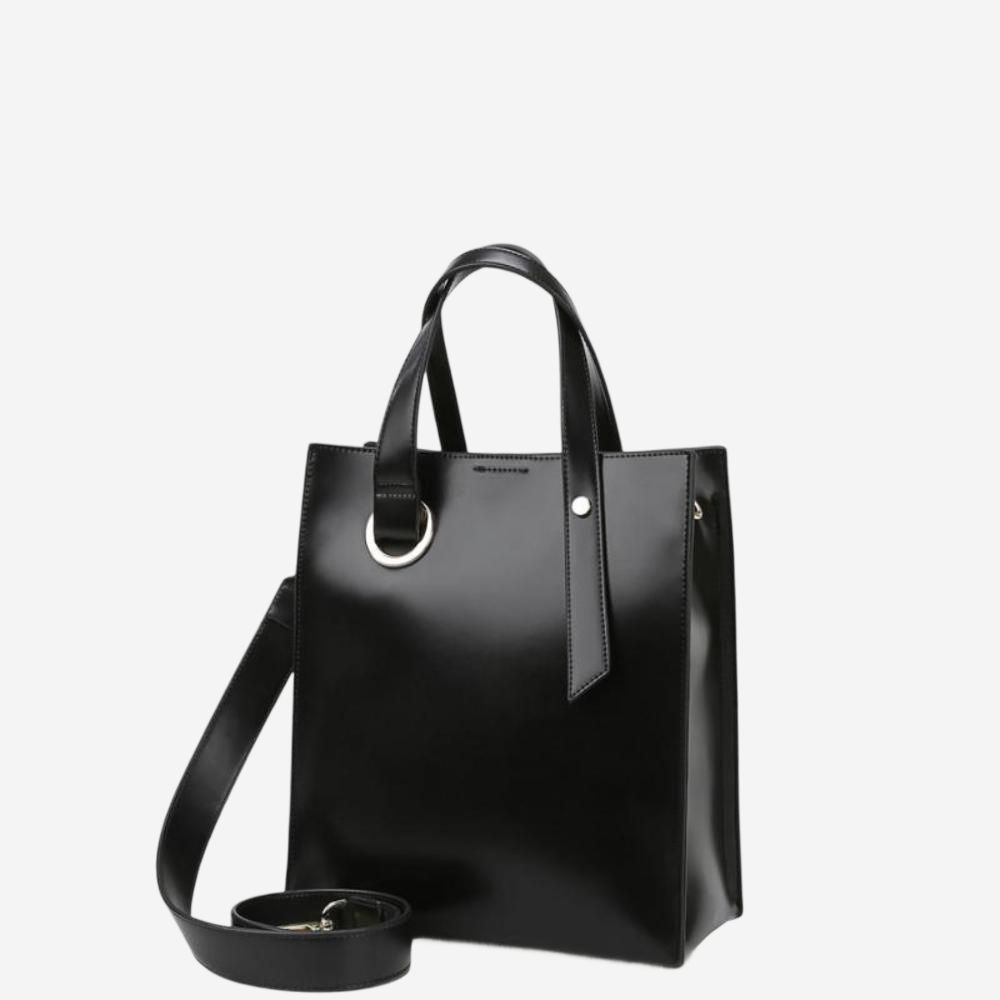 A sleek black leather tote bag with a metal ring on the front and a metal strap.